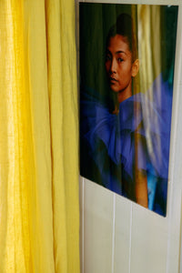 Volt plexi portrait by HKLIVING hung against a wall beside a yellow curtain