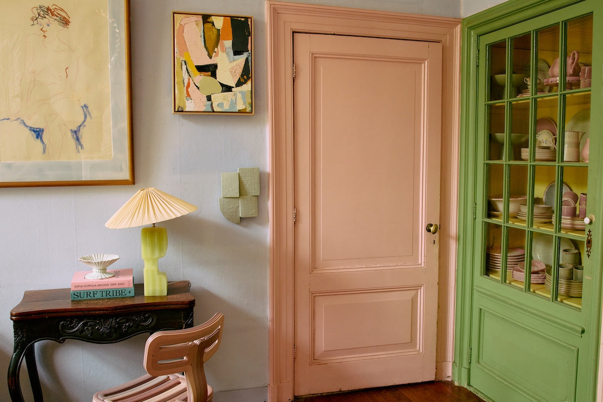 Sage green Levels wall sculpture styled near a pink painted doorway