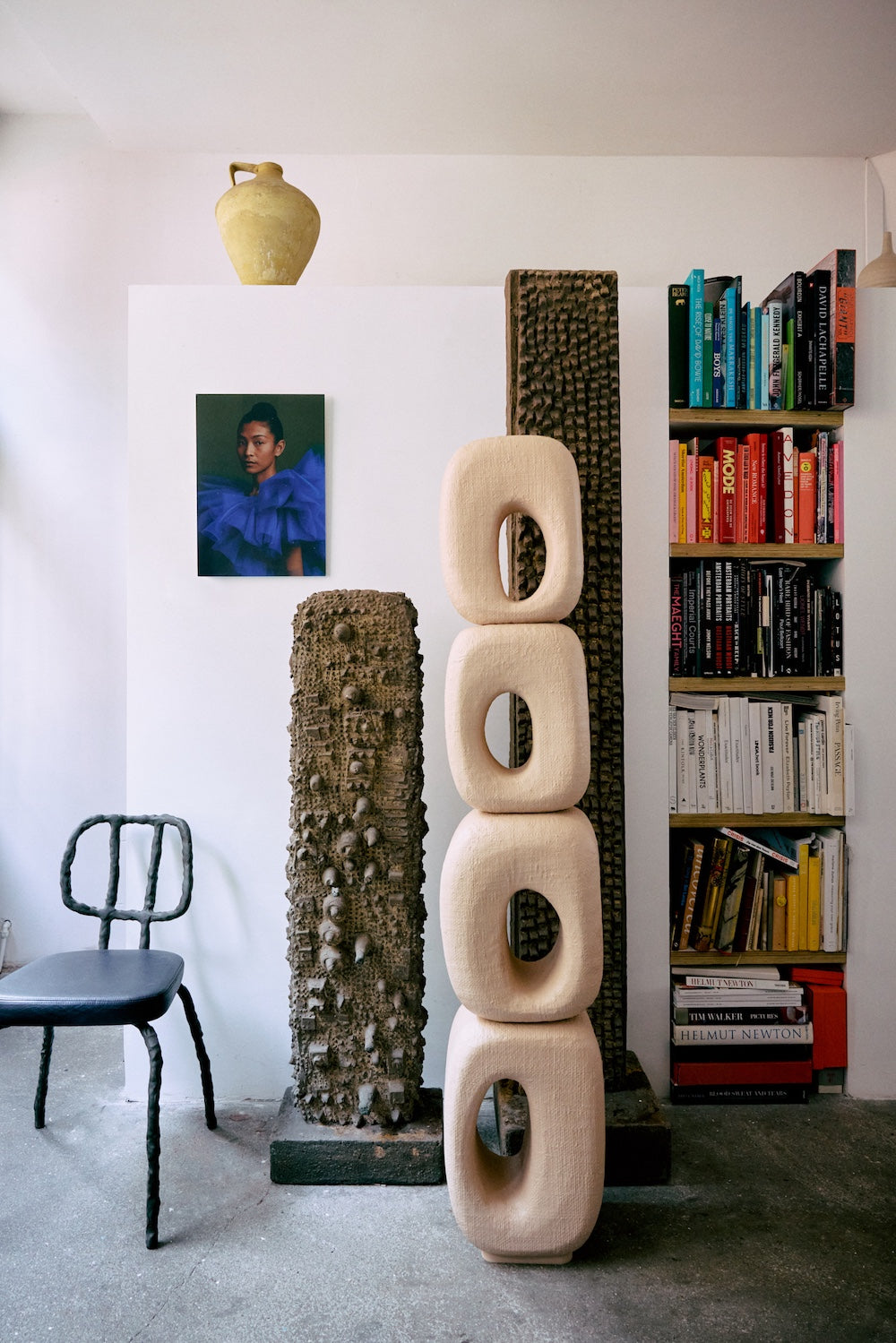 Volt plexi portrait by HKLIVING displayed on a plinth beside sculptural ceramic pieces and a bookshelf