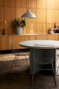 Wooden panelled kitchen with HKLIVING pale mint floor vase styled with dried flowers on a terrazzo countertop