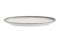 oval ceramic serving dish showing shallow profile and reactive glaze edge
