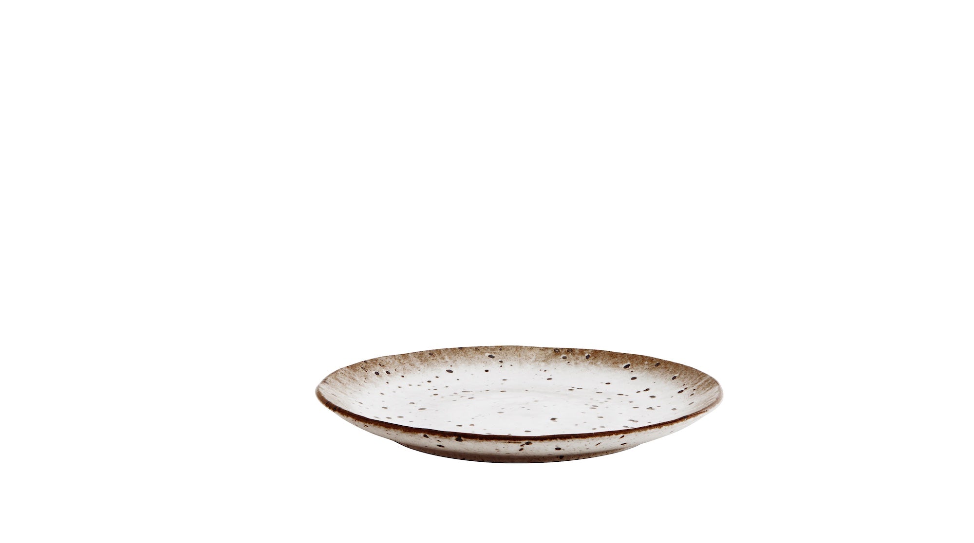 stacked stoneware plates and bowls with speckled glaze and earthy tones
