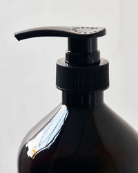 Meraki Herbal Nest dish wash bottle styled with glassware and linen