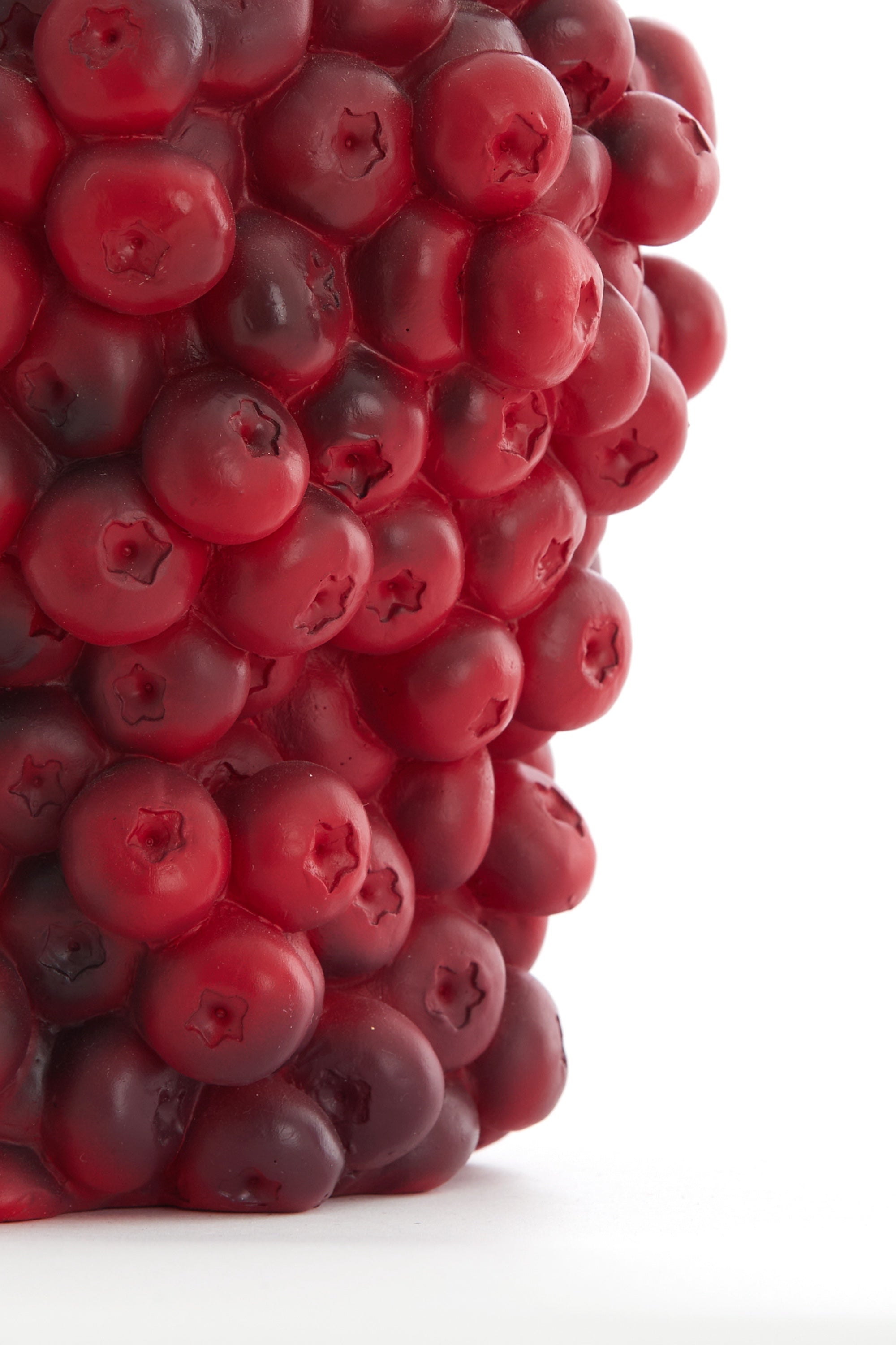 detailed view of red berry-textured vase surface showing rich shading
