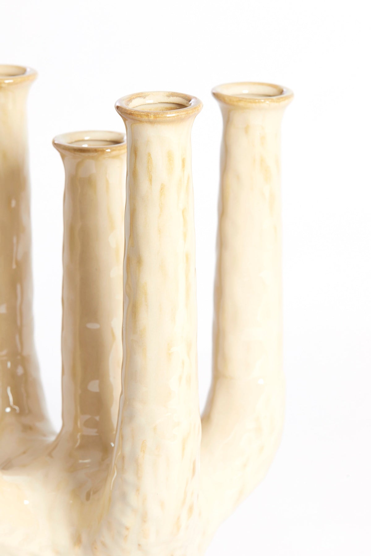 close-up of sand-beige sculptural ceramic vase with glossy textured finish