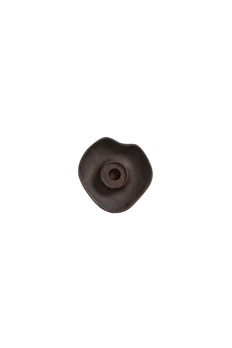dark brown wooden candle holder with organic shape and central taper candle inset
