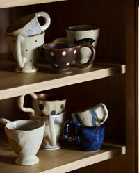 Close-up of the ZINA cup by Nordal's brown glaze and hand-painted cream dots