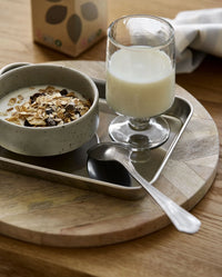 LUCIDUS chrome tray S by Nordal styled with a coffee cup, dotted plate and macadamia nuts