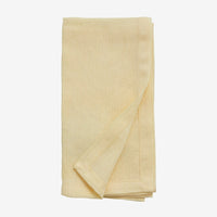 hand hemmed cloth yellow napkin folded neatly 