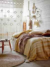 warm earthy bedroom with recycled cotton katrin bolster cushion in brown stripes