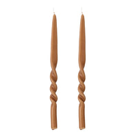 pair of brown hand-twisted taper candles by bloomingville on white background
