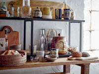 Lobelia cups in blue stripe and blue yellow displayed on open kitchen shelf

