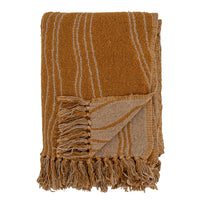 folded ginna throw in brown showing fringes and reversible wavy pattern
