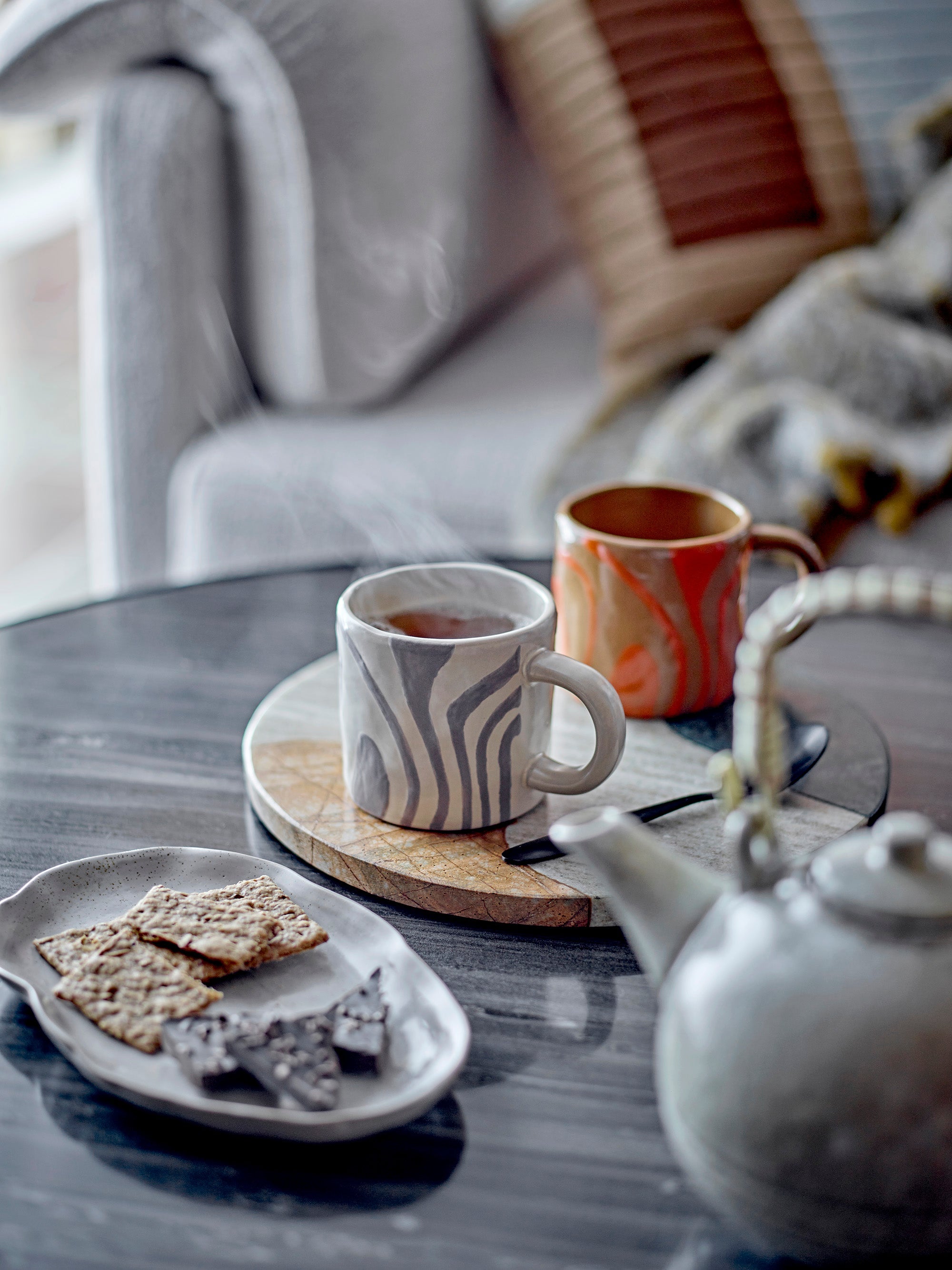 grey ninka stoneware mug by bloomingville styled on round marble board with tea