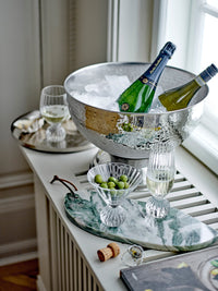 Taurin cocktail glasses styled with drinks and olives at a party, on a marble tray
