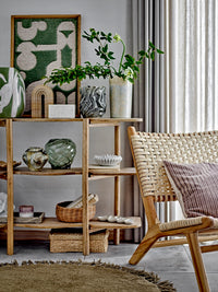 Adalena green stoneware vase styled on a wooden shelf with other decorative objects