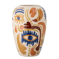 Ceramic vase with abstract face design on a white background