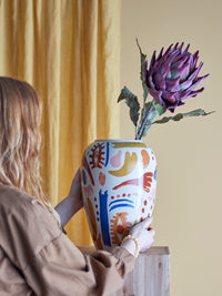 Horus multicolour vase styled on wooden chest of drawers with flowers