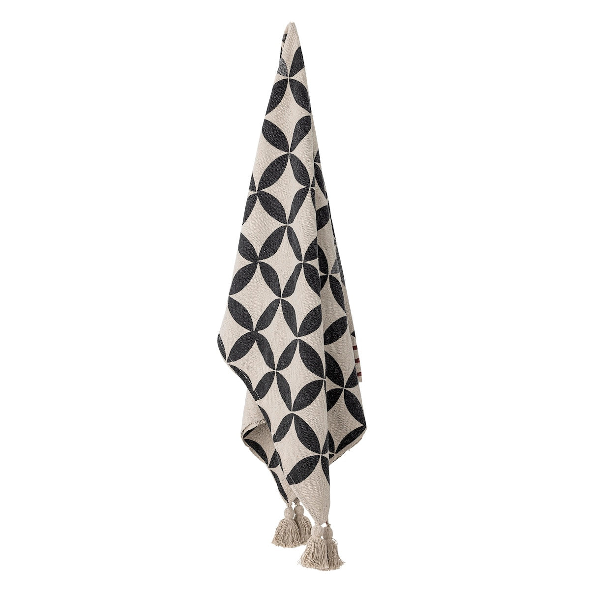 Forma throw hanging showing full geometric petal pattern and tassels