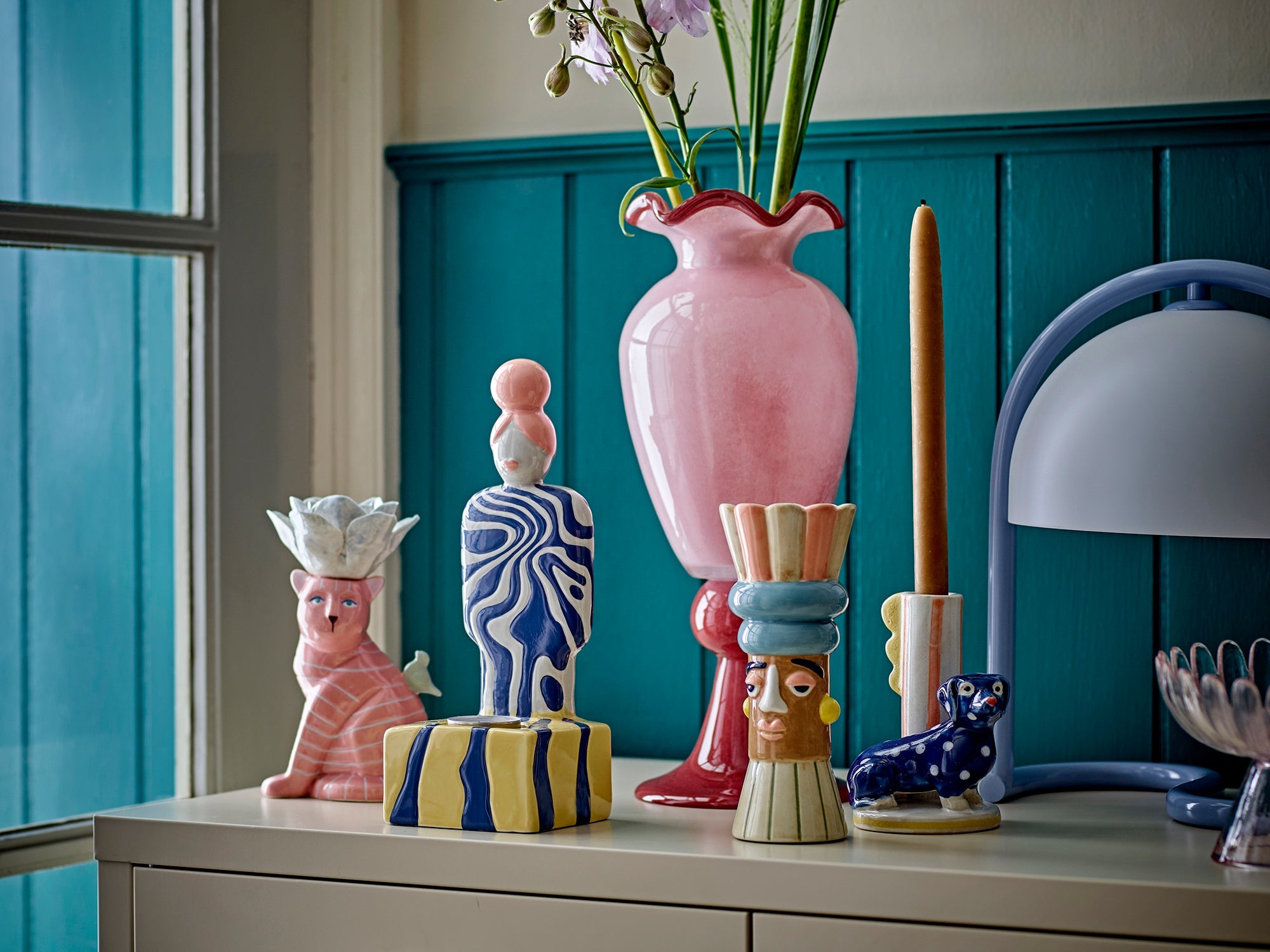 pink frills vase by bloomingville styled with bold home accessories and flowers
