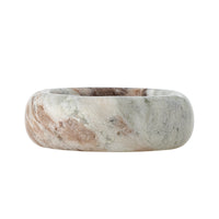 Side view of the Indah marble bowl showing its thick, rounded rim and grey, cream and brown veining