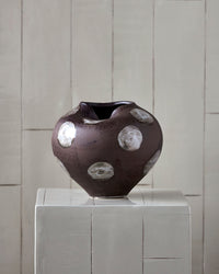 House Doctor Expo vase styled on a white plinth against a pale tiled wall, a sculptural focal point for entryways and modern bohemian interiors