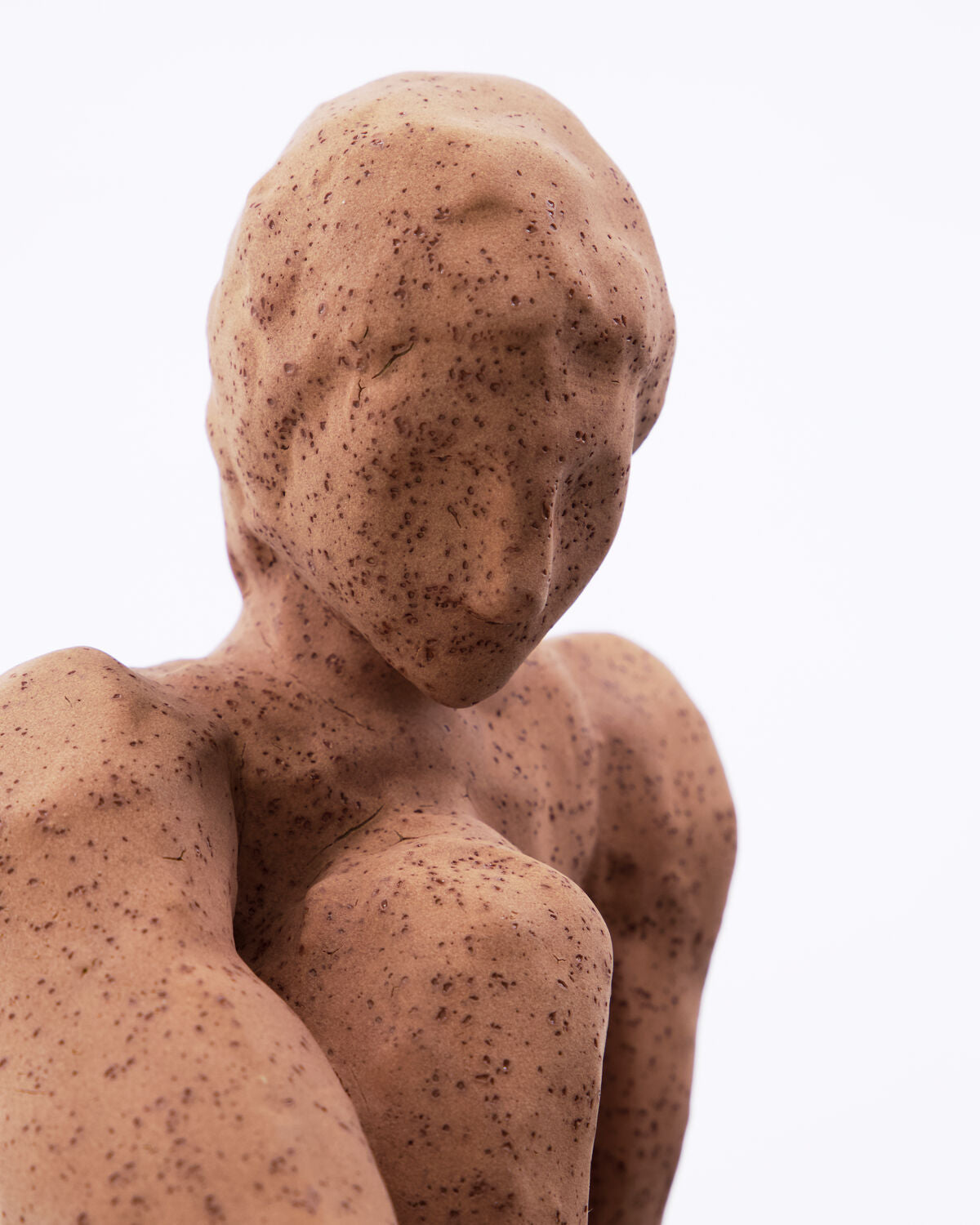 Close-up of the abstract face and shoulders of the House Doctor Woman sculpture in warm speckled stoneware, showing the handmade tactile finish