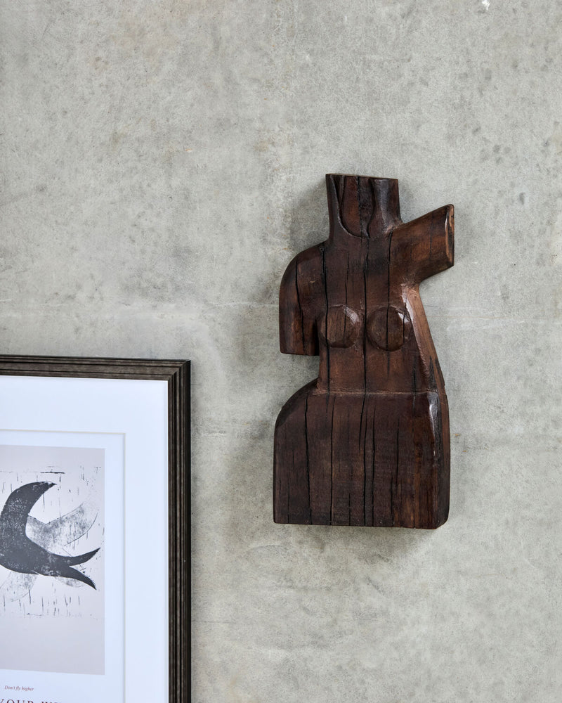 House Doctor Human wall art styled on a plaster wall beside a framed graphic print, a sculptural female figure piece for a curated modern gallery wall