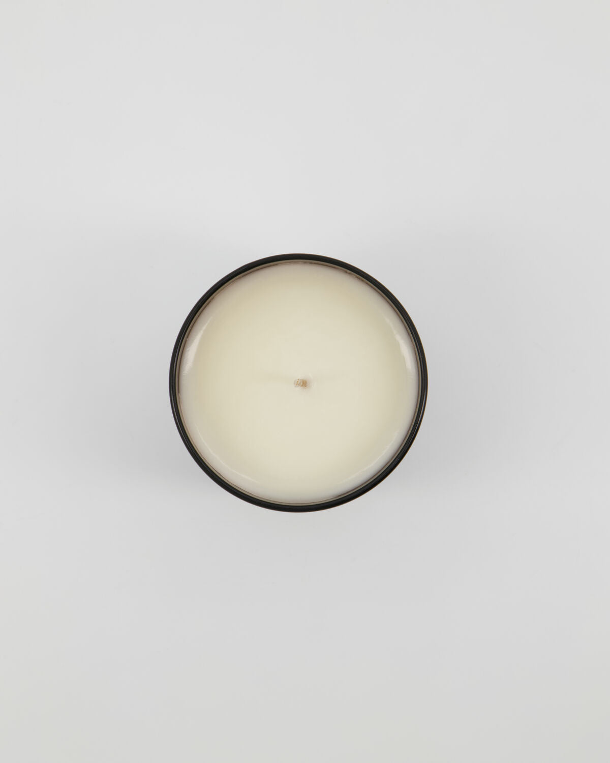 Top-down view of the Meraki Amber Dust candle showing the wax and wick