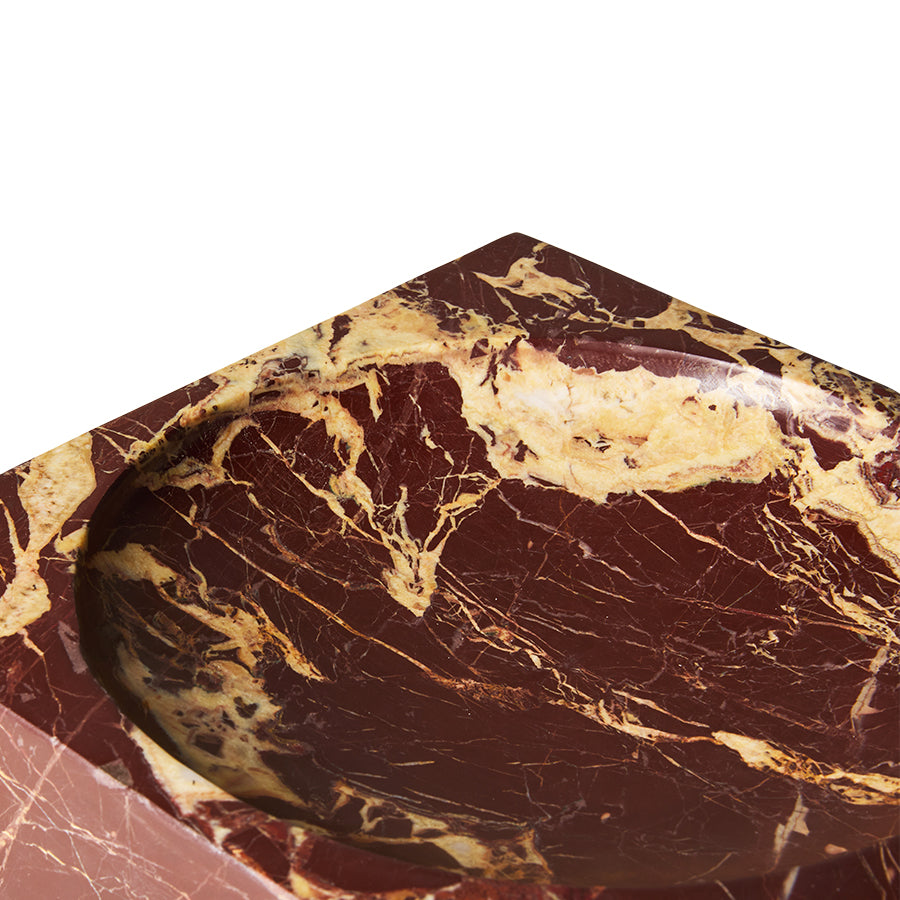 Burgundy marble cube in a styled interior