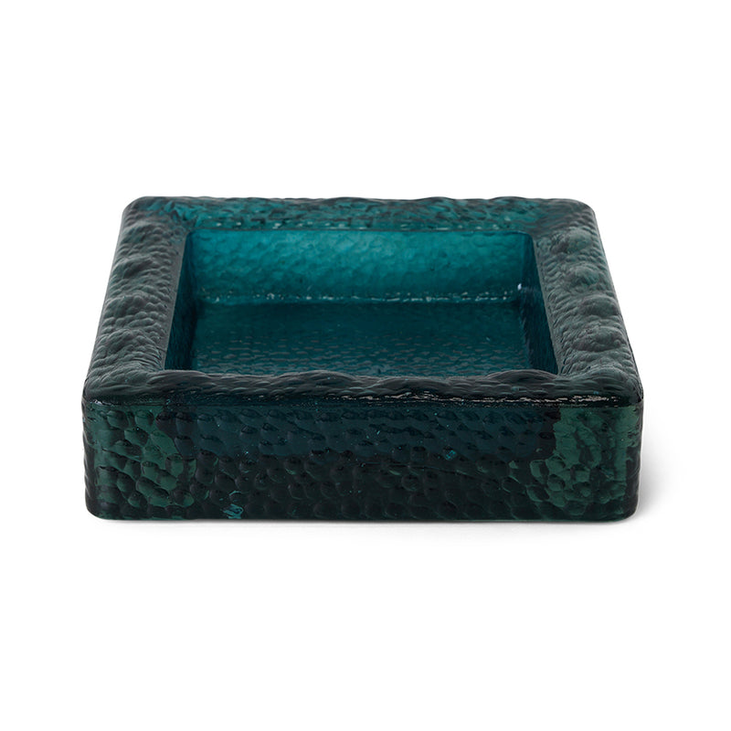 Teal sculptural square bowl styled on a coffee table