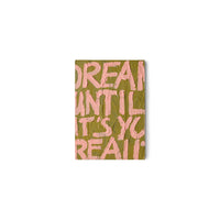 HKLIVING Pocket Exhibit 'Manifest', a hand-painted typographic MDF wall piece reading 'Dream until it's your reality' in pink on olive green, on a plain white background