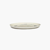 side view of the off white plate wiht black stripes from ottolenghi by serax feast range with a luxurious level of glaze