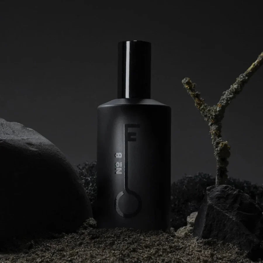 black bottle of fischersund number 8 that was handmade in iceland stood among black rocks and moss