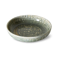 Medium rustic green deep plate by HKLIVING at an angle, showing the ringed centre
