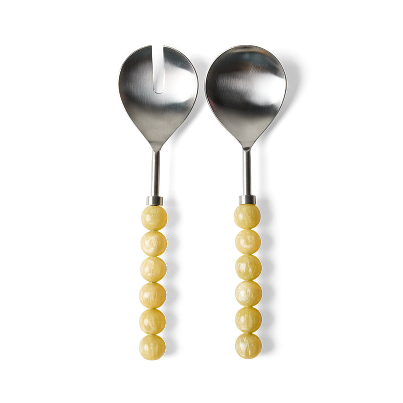 Lemon salad servers by HKLIVING on a white background, showing the stainless steel heads (one slotted, one solid) and pale lemon-yellow bead-style resin handles