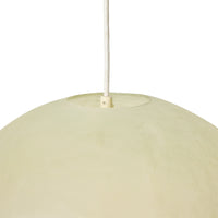 Large glassfibre pendant lamp styled above a dining table
