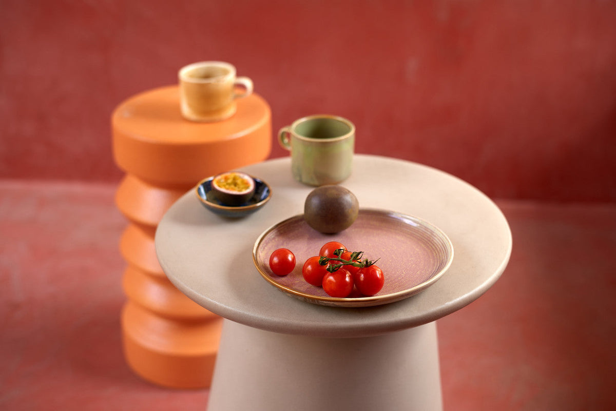 HKLIVING small plate with cherry tomatoes on a pink pedestal table against a red wall