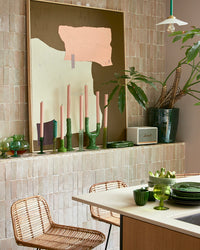 HKLIVING abstract painting in mustard brown, cream and peach hung above a kitchen counter with plants and a rattan stool