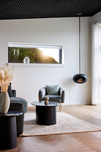 Black Le Feu Sky designer fireplace suspended from ceiling in open-plan living room