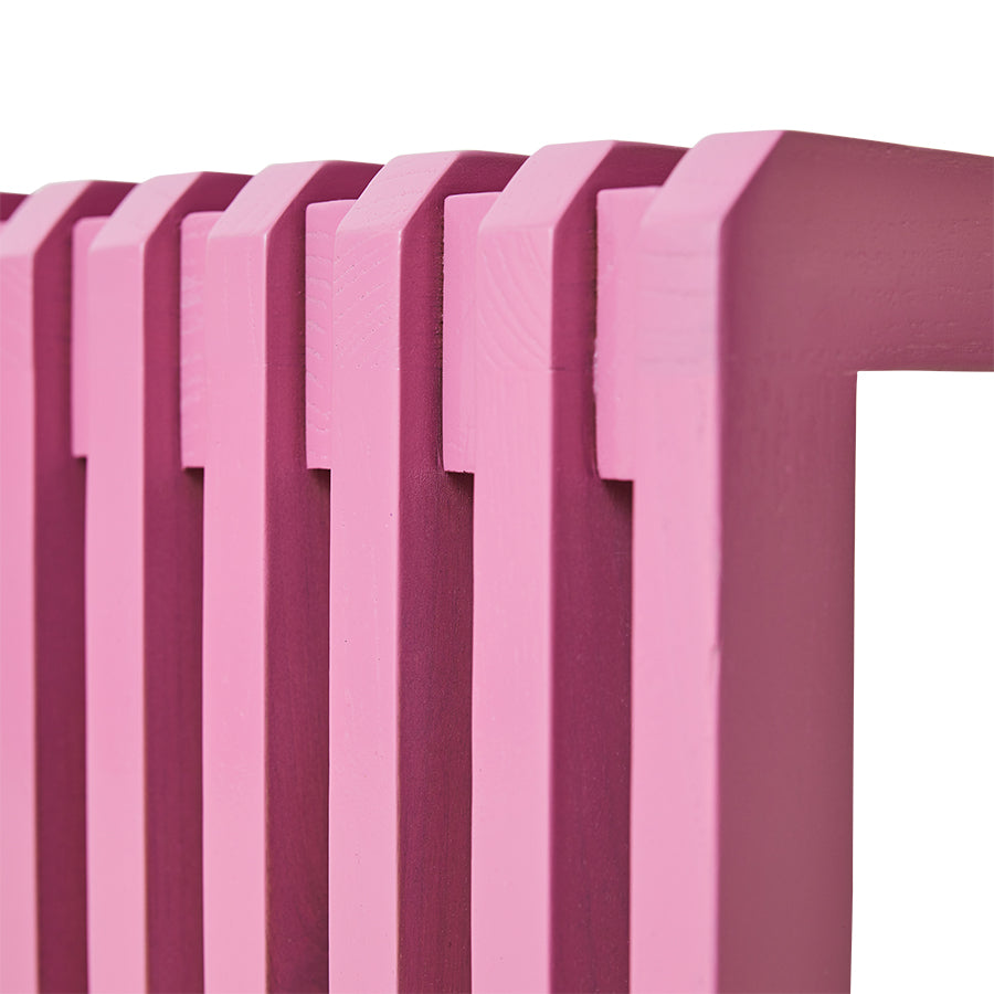Vibrant pink sungkai wood bench styled as a feature piece in a large room