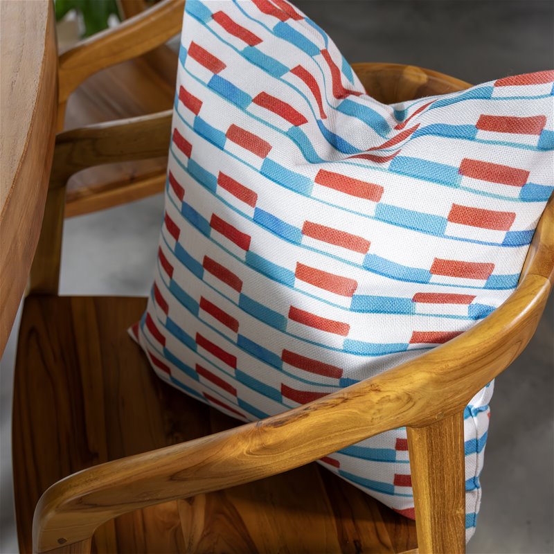 colourful red and blue patterned &k Amsterdam cushion on wooden chair
