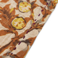 close up of a cloth napkin with yellow and browns and a purple stich around the edge from the dutch deisgn house hk living