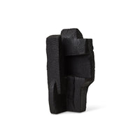 abstract burned wooden sculpture showing textured charred surface
