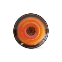 with the heat in the centre of this saucer created by a switling lava surrounded by a pink ring almost like images of the core of the earth in this 70s ceramics item from hkliving