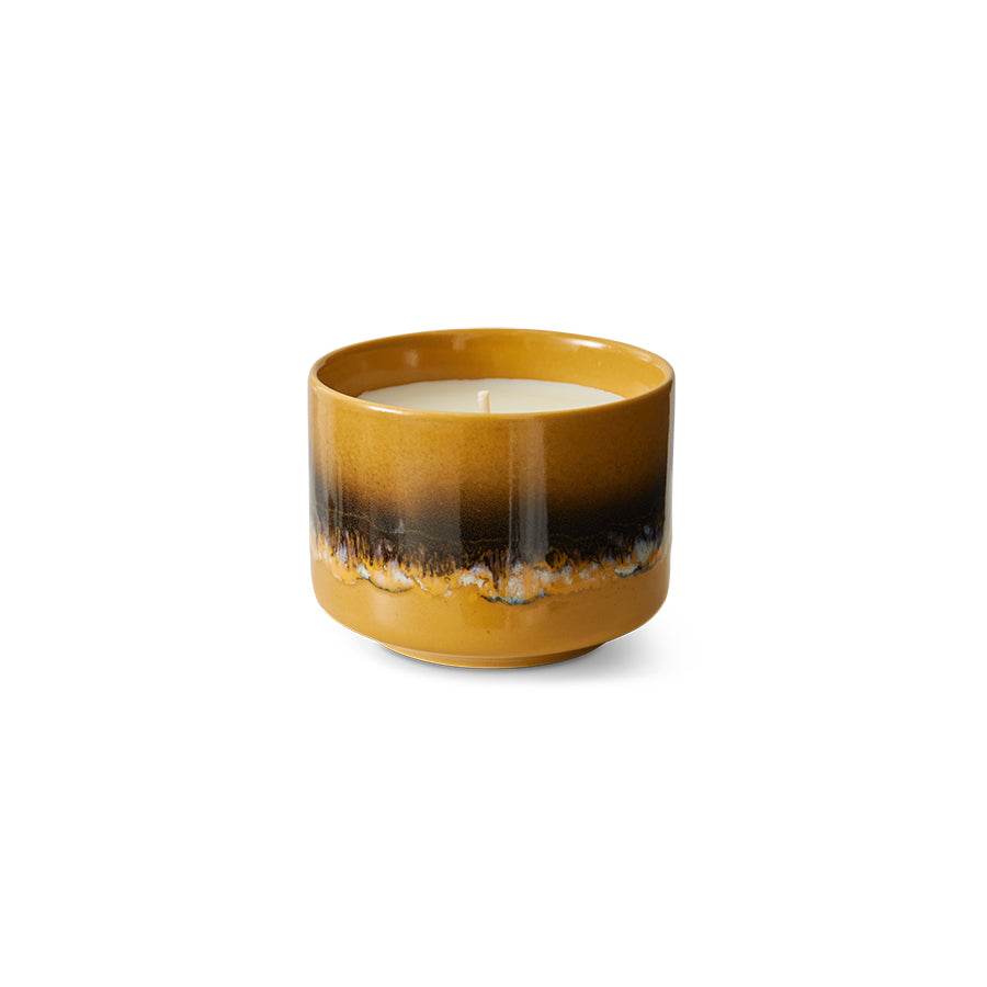 Candle in a ceramic holder with gradient color on a white background with vanilla and spice fragrance notes