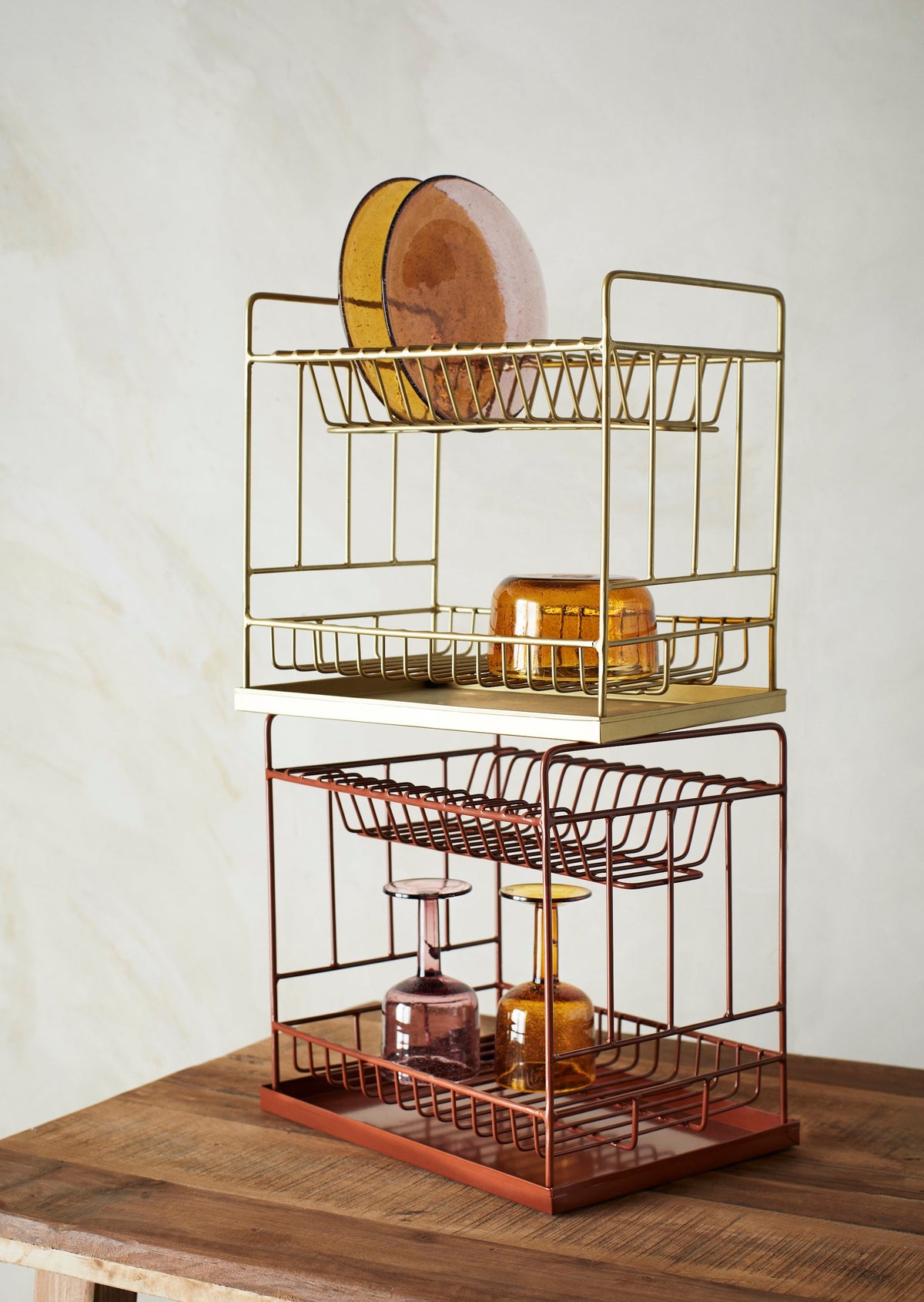 amber bubbled wine glass styled on gold kitchen rack

