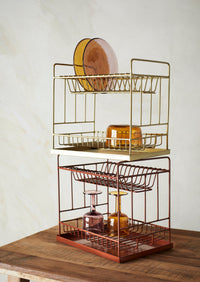 amber bubbled wine glass styled on gold kitchen rack
