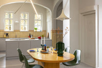 Amfora vase styled on a dining table showing bold, sculptural silhouette for modern spaces.
