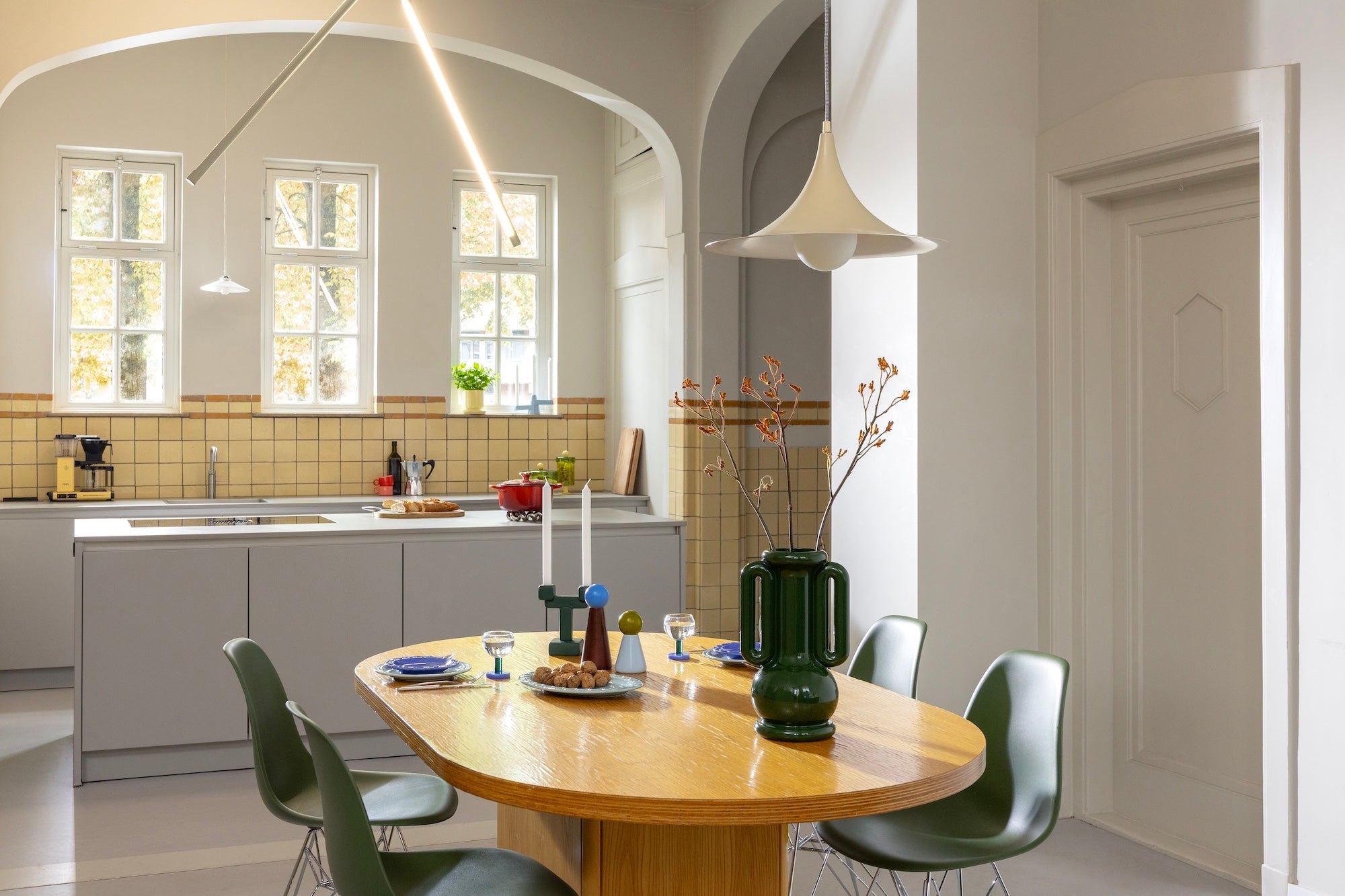 Amfora vase styled on a dining table showing bold, sculptural silhouette for modern spaces.
